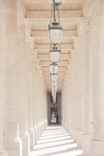 Load image into Gallery viewer, Palais Royal colonnade Paris France neutral white cream colours, row of hanging lanterns. 

