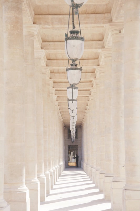 Palais Royal colonnade Paris France neutral white cream colours, row of hanging lanterns. 