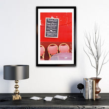 Load image into Gallery viewer, Red Café wall in Montmartre Paris with menu board and French café table and chairs 
