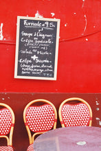 Load image into Gallery viewer, Red Café wall in Montmartre Paris with menu board and French café table and chairs 
