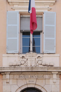 Doorway and window and shutters, French flag, at the Hôtel,de Ville town hall, antibes France Côte d’Azur south of France French Riviera 