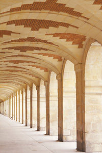 arched gallery at the place des vosges in the marais paris france